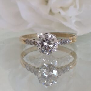 AMS8988 Early C20th solitaire with diamond set shoulders